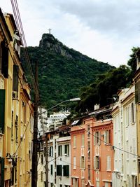 Low angle view of buildings in town against sky