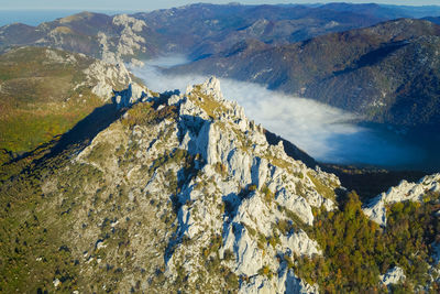 Dabarski kukovi rocks with the mist in the valley on the velebit mountain, croatia