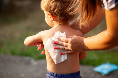 Midsection of child holding hands