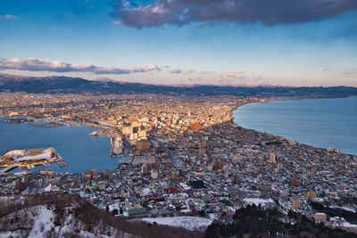 High angle view of townscape by sea against sky