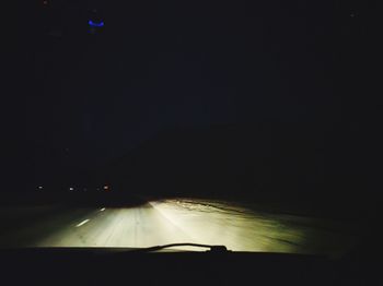 Illuminated car against sky at night