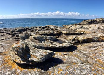 Rocks on beach against sky