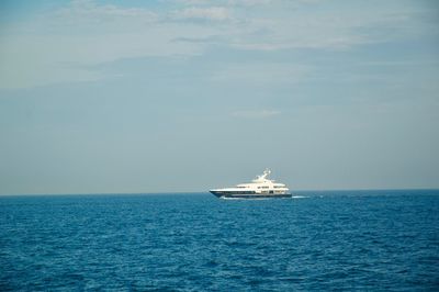 Ship sailing on sea against sky