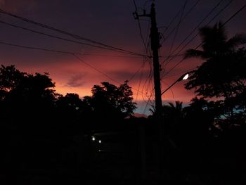 Low angle view of silhouette trees against sky at sunset