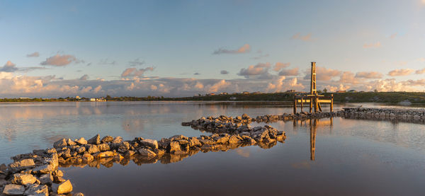 Scenic view old windmill in salt pond at sunrise 