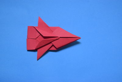 Close-up of paper flag against blue sky