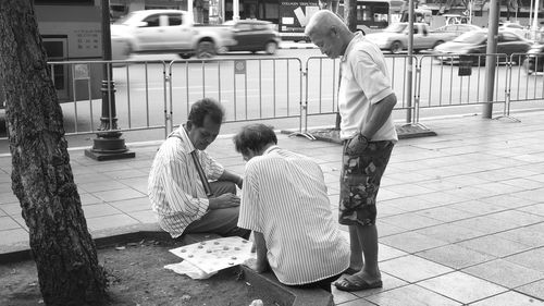 Rear view of people sitting outdoors