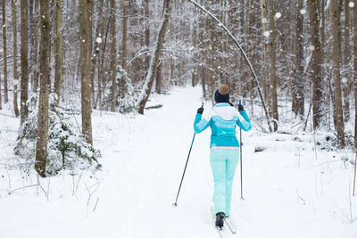 Full length of man skiing on snow covered landscape