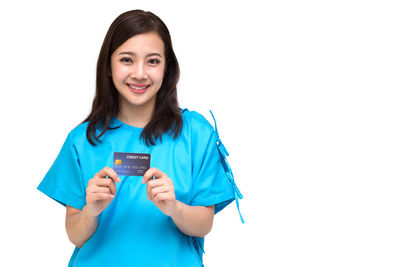 Portrait of a smiling young woman against white background