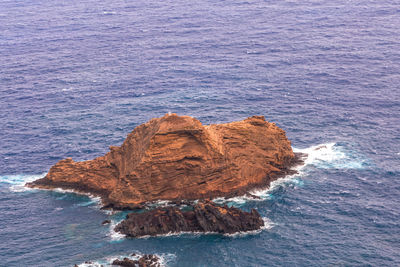 High angle view of rock in sea