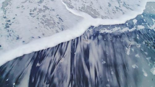 Panoramic view of frozen sea against snowcapped mountain