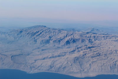 Aerial view of mountains against sky seen from airplane