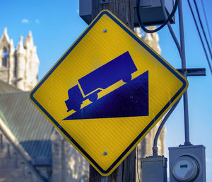 Road sign against sky in city