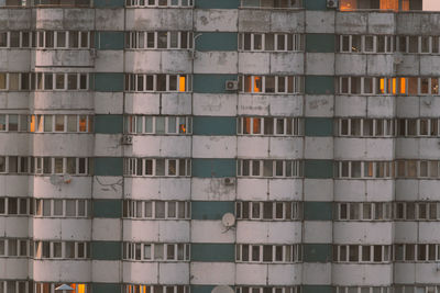 Reflection of sunlight in the windows of an old high-rise building