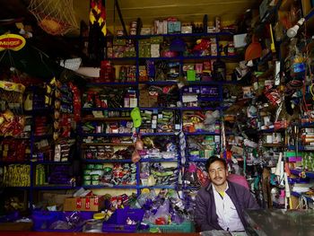 Portrait of man standing at market stall