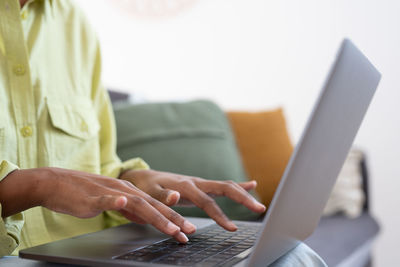 Midsection of woman using laptop