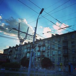 Low angle view of electricity pylon against sky