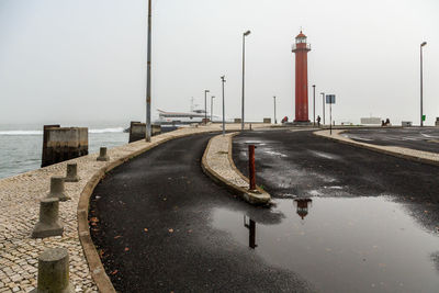 Road by sea against clear sky