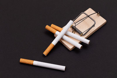 High angle view of cigarette on table against black background