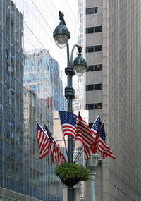 Low angle view of flag against buildings in city