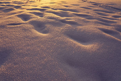 High angle view of footprints on sand at beach