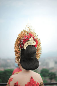 Rear view of woman looking against sky with javanese traditional clothes from indonesia