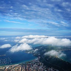 High angle view of sea and cityscape against sky