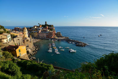 High angle view of buildings by sea against sky