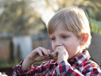 Portrait of cute boy holding camera