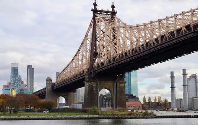 View of bridge over river against cloudy sky