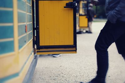 Low section of person on yellow surface