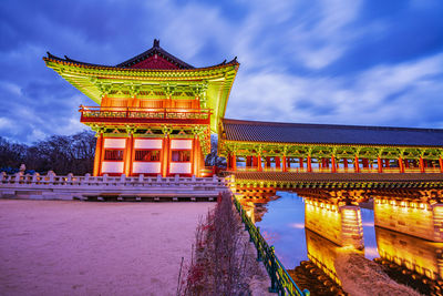 Low angle view of illuminated building against sky