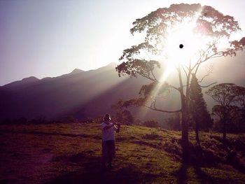 Full length of silhouette man standing against sky during sunset