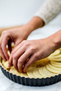 Close-up of woman preparing apple pie
