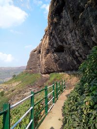 Rock formations by mountain against sky