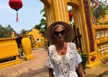 Portrait of woman wearing sunglasses standing outdoors