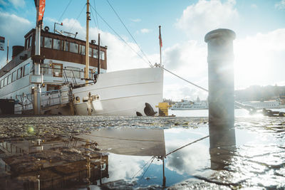 View of factory by sea against sky