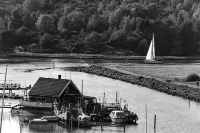 Boats moored on lake against sky