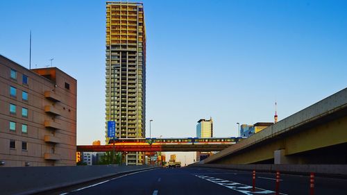 Empty road along buildings