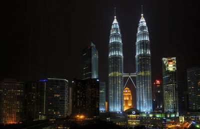 Illuminated modern buildings in city at night