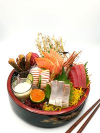 Close-up of fish served on table against white background