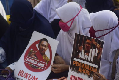 Close-up of people with text