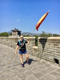 Raise the flags. weaving a flag in the great wall of china.