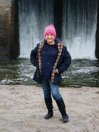 Full length portrait of woman standing in snow