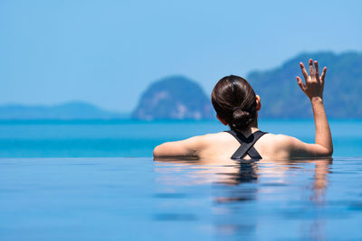 Rear view of woman in swimming pool