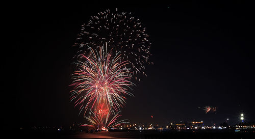 Low angle view of firework display at night