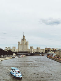 Boats in river with buildings in background