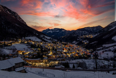 Mountain village icon snow at sunset