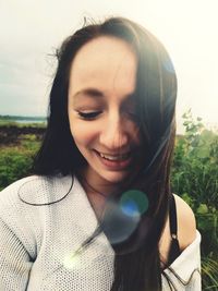 Close-up of smiling woman looking down