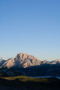 Scenic view of mountains against clear blue sky